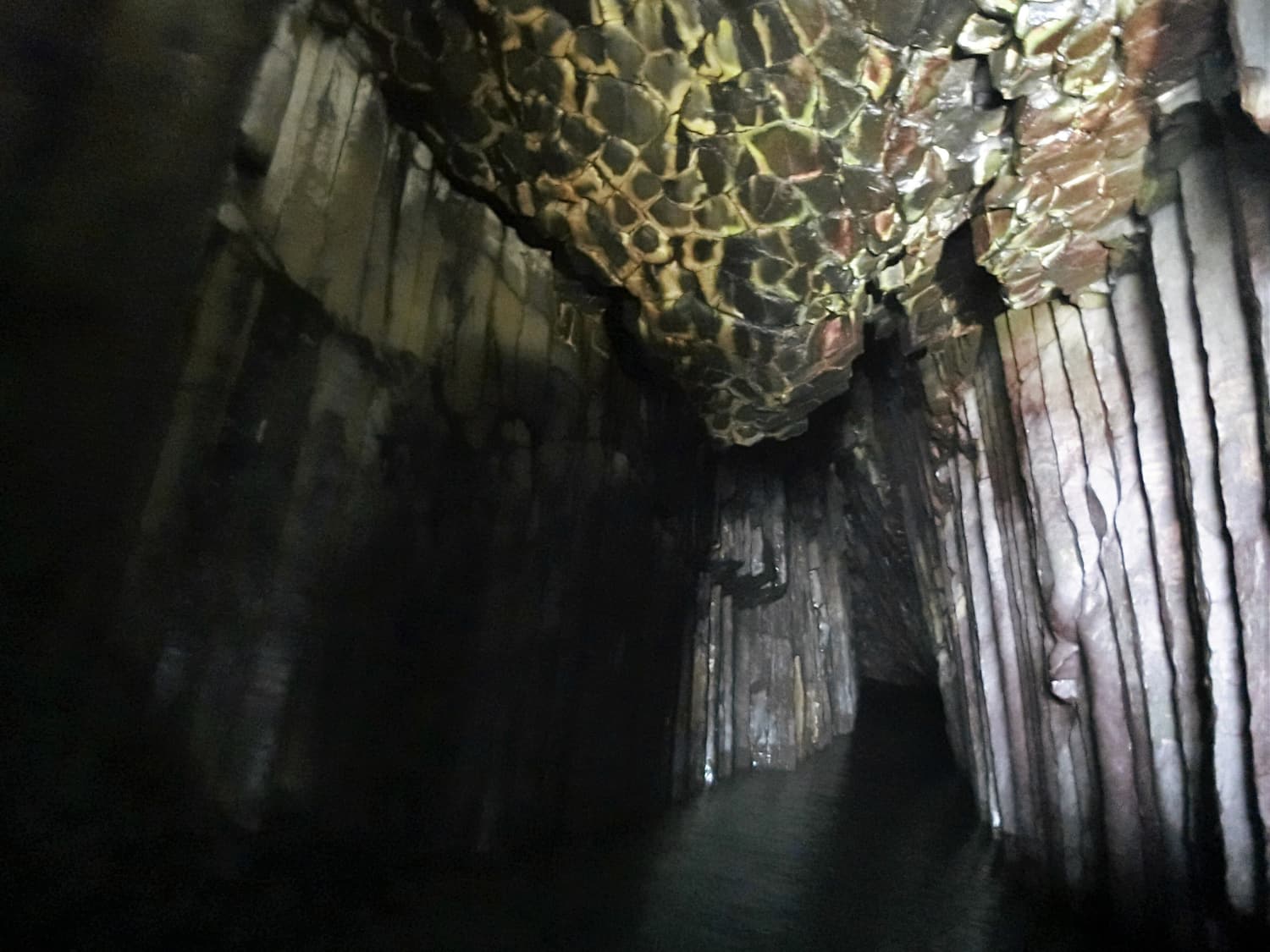 The basalt columns inside the Keya no Oto sea cave seen from the bow of a sightseeing boat