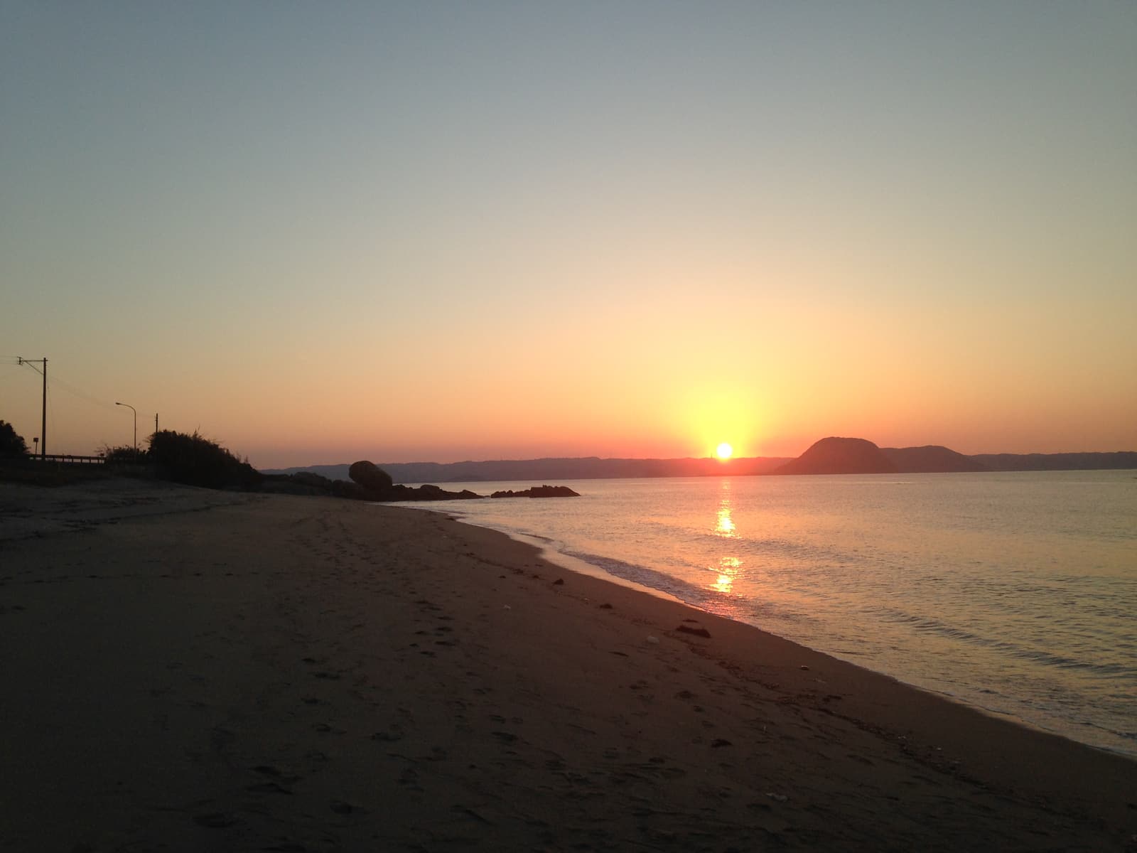 The sun setting into the sea off a beach on Itoshima’s west coast