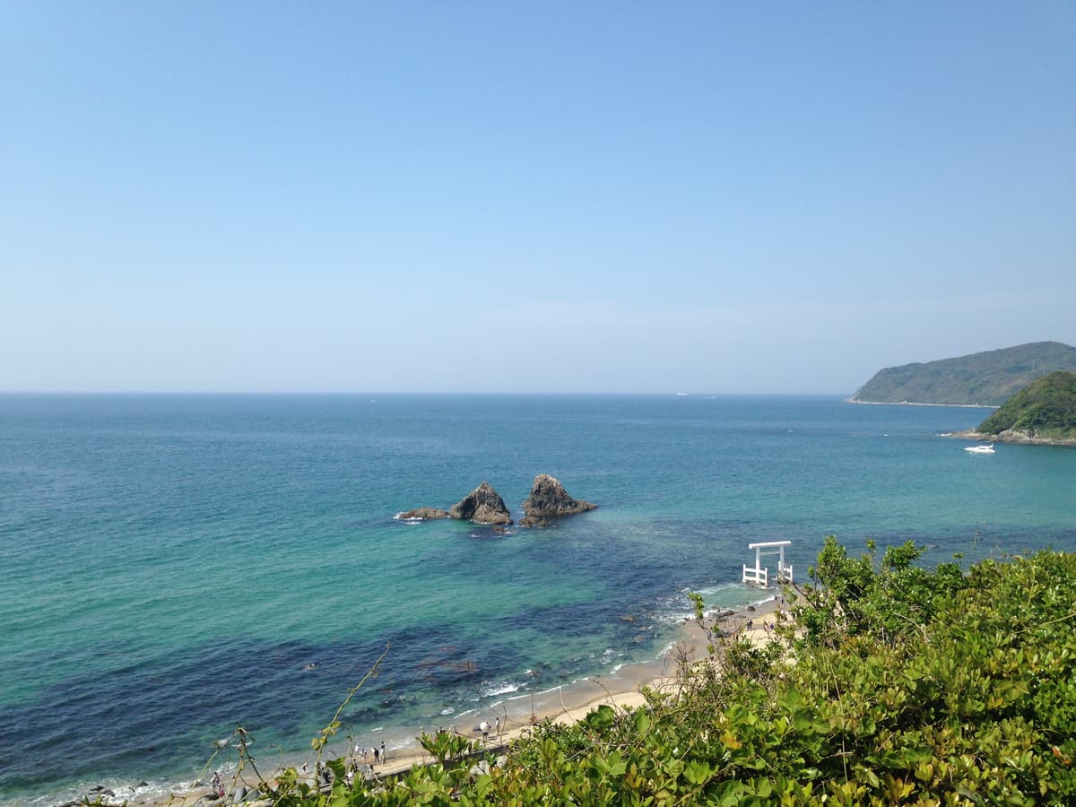 The married rocks and torii of Sakurai Futamigaura seen from a hillside above the coast