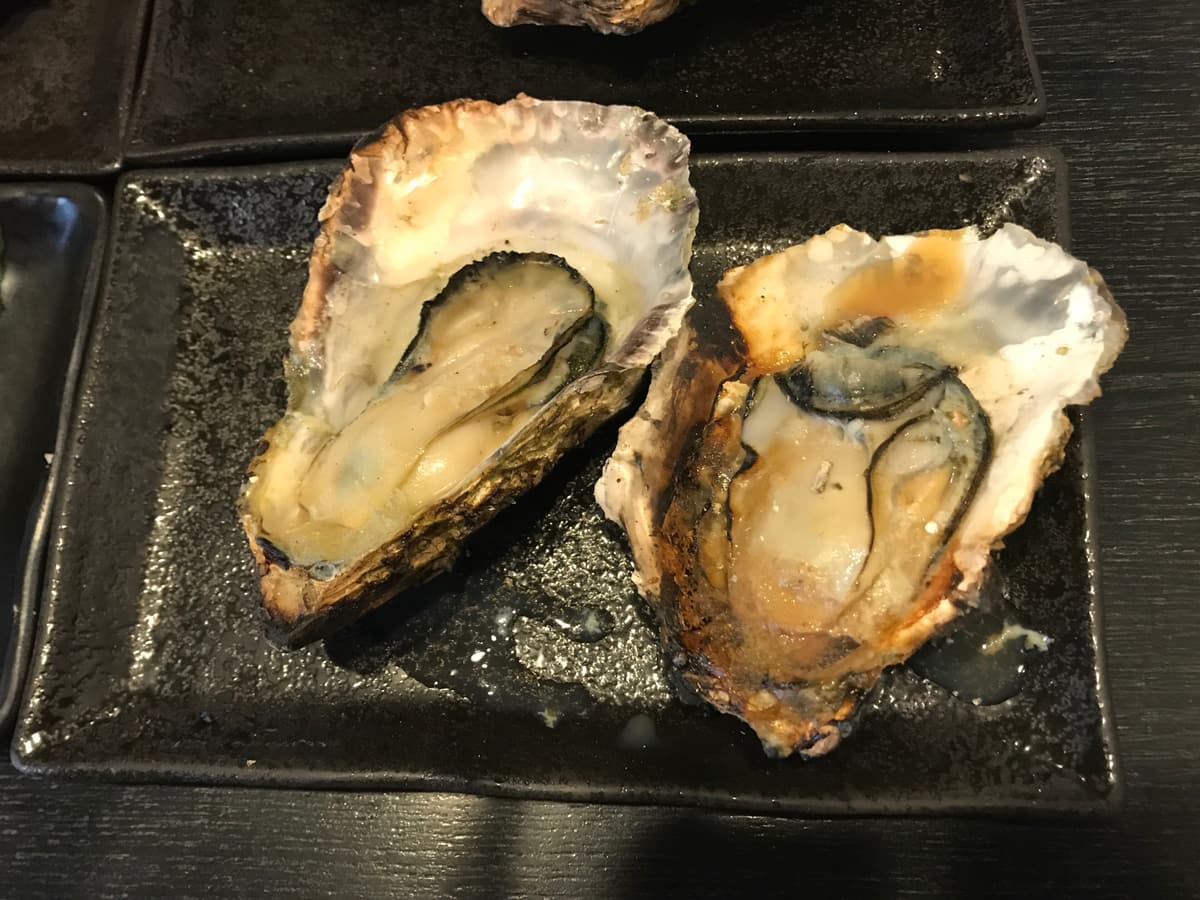 Two grilled oysters on the half shell
