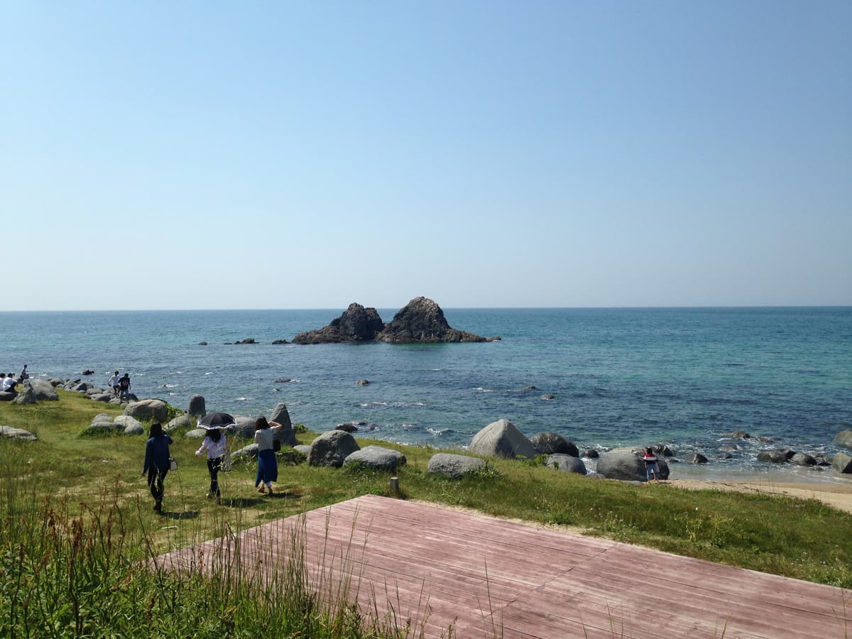 The married rocks of Sakurai Futamigaura seen from the grassy shore, Itoshima