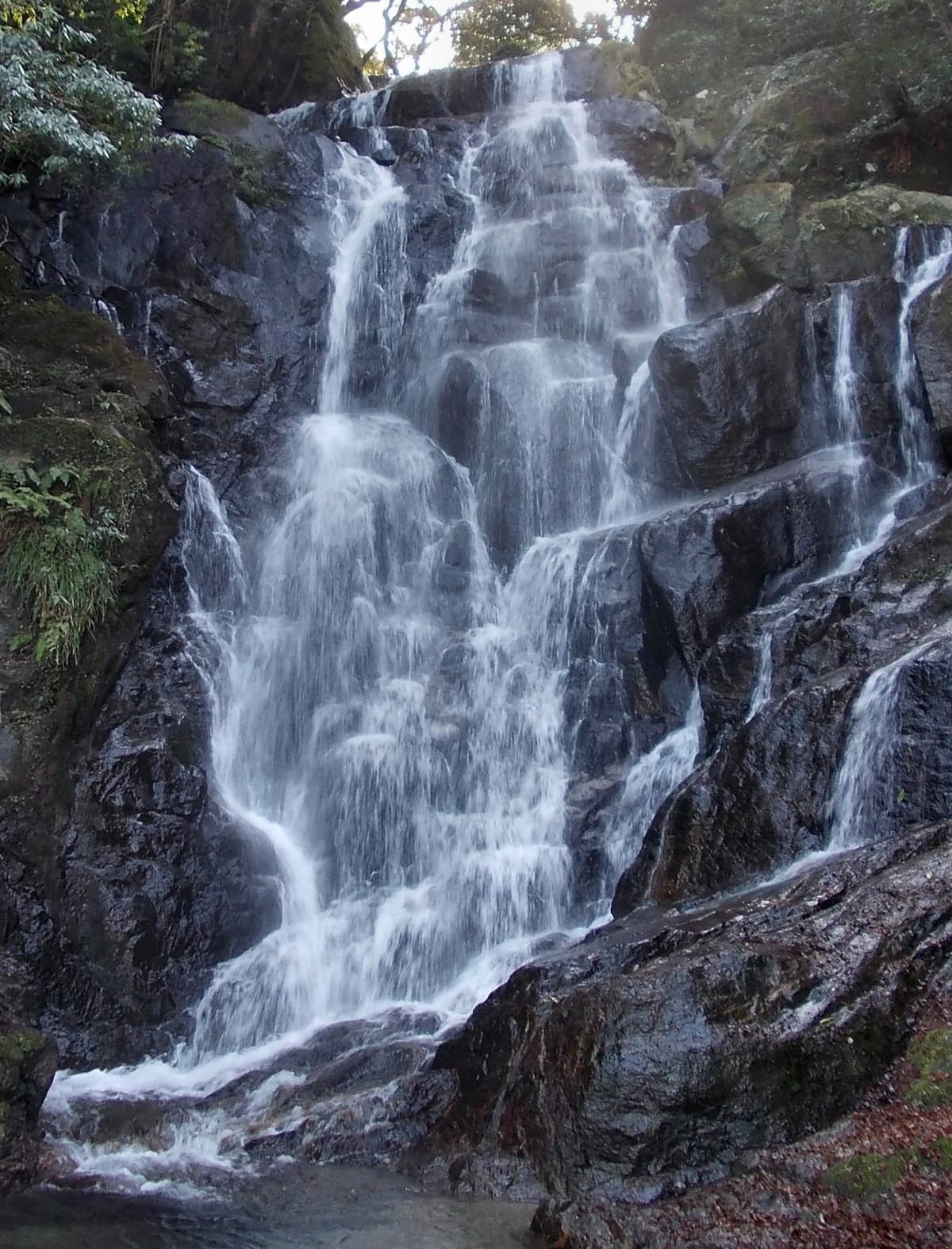 Shiraito Falls in Itoshima cascading over dark rock